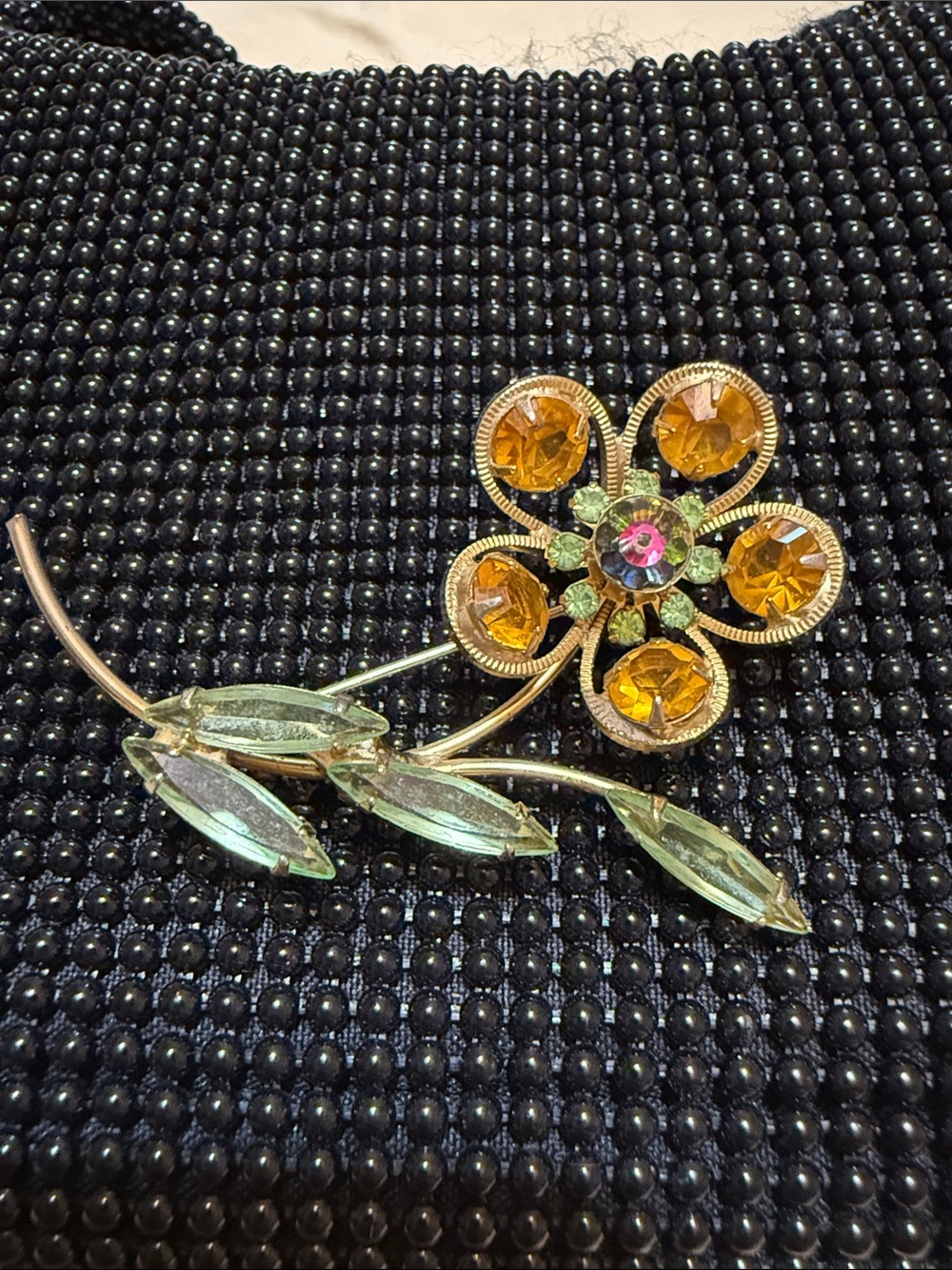 Vintage 70s Gold-Tone Orange Crystal Flower Brooch with Green Leaf Accents